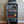 Front view of rustic gray 3-tier record stand styled with books, globe, and record player.