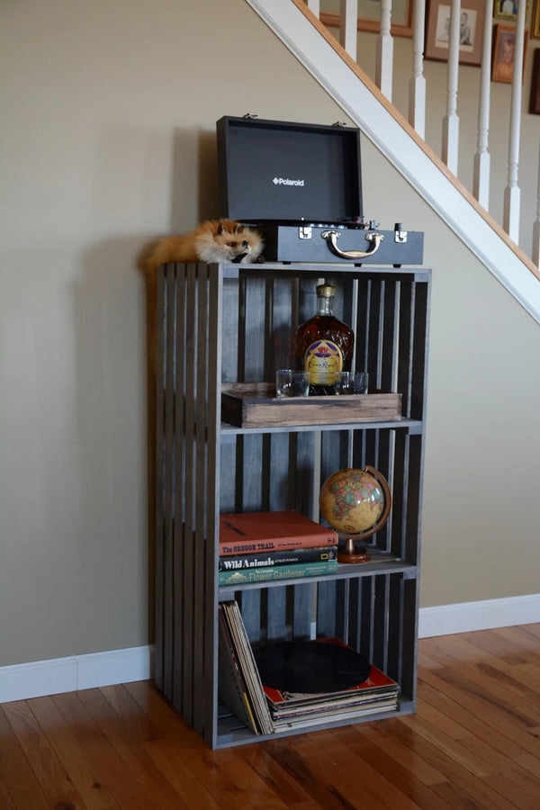 Gray 3-tier turntable stand displayed with record player, globe, and vintage books in a home setting.