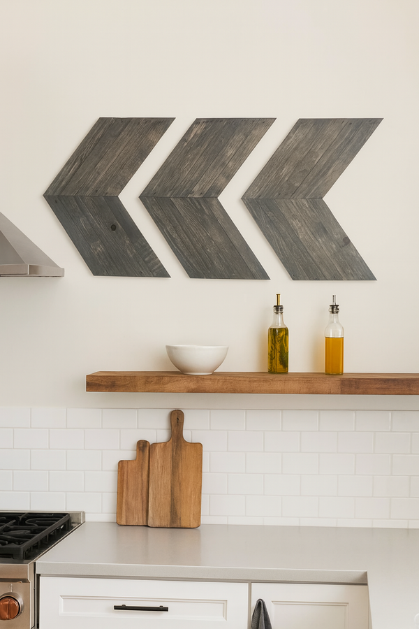 Rustic gray chevron wall art set of 3 mounted above kitchen shelf with cutting boards and oil bottles.