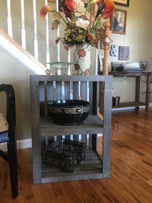 Farmhouse gray end table with decorative vase and bowls.