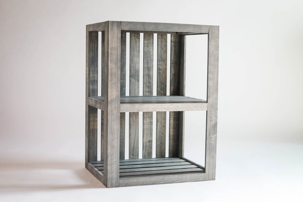 Rustic gray wooden end table with two shelves on white background.