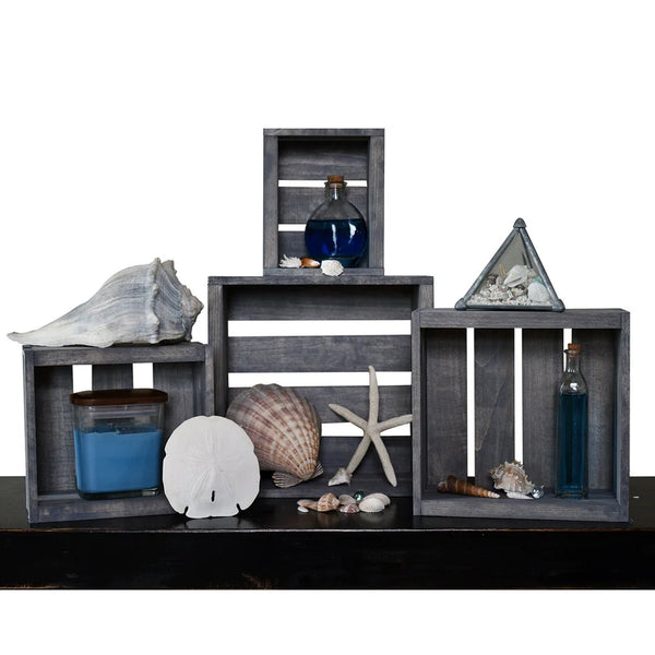 Rustic gray wooden nesting crates styled as farmhouse shelf decor with seashells.