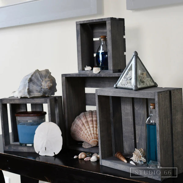 Farmhouse gray nesting crates decorated with shells, bottles, and coastal accents.