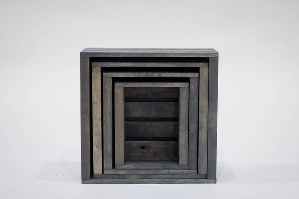 Set of rustic gray wooden crates nested inside each other for compact storage.