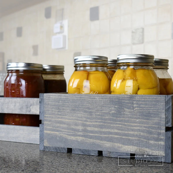 Rustic gray farmhouse crate holding canned goods and pantry storage items.