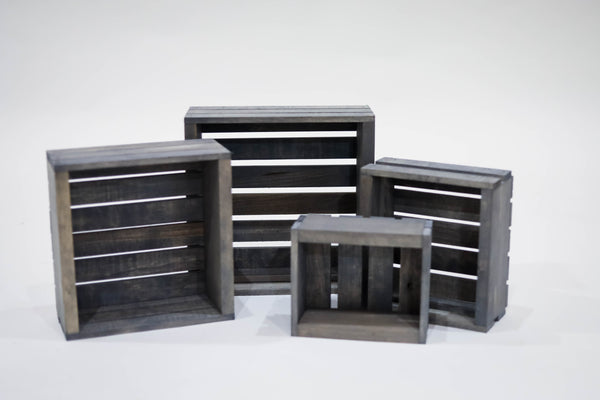 Set of four rustic gray nesting crates displayed on white background.
