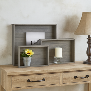 Rustic gray wooden tray set styled on farmhouse console table with lamp.