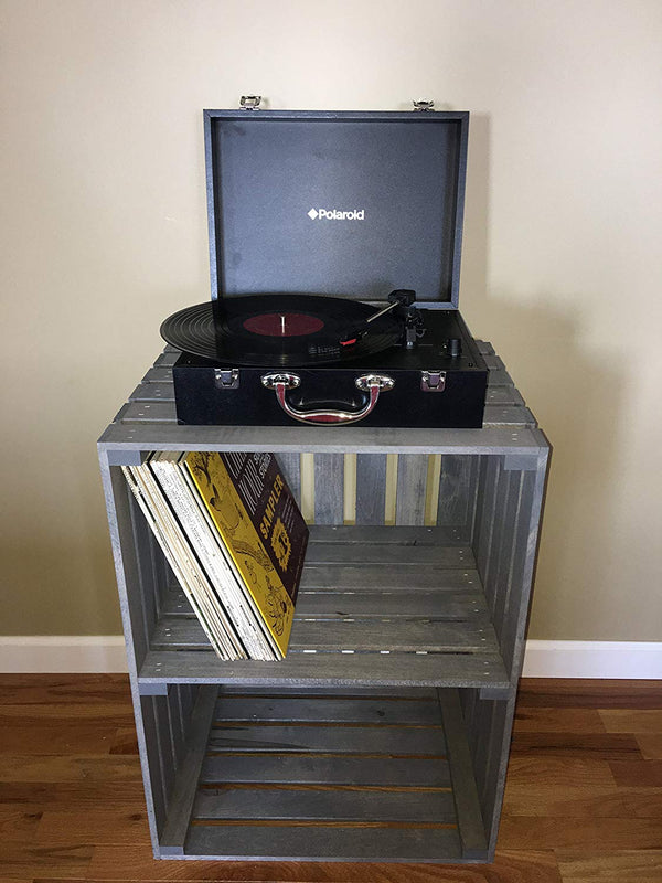 Gray 2-tier wooden turntable stand holding vinyl records and record player.