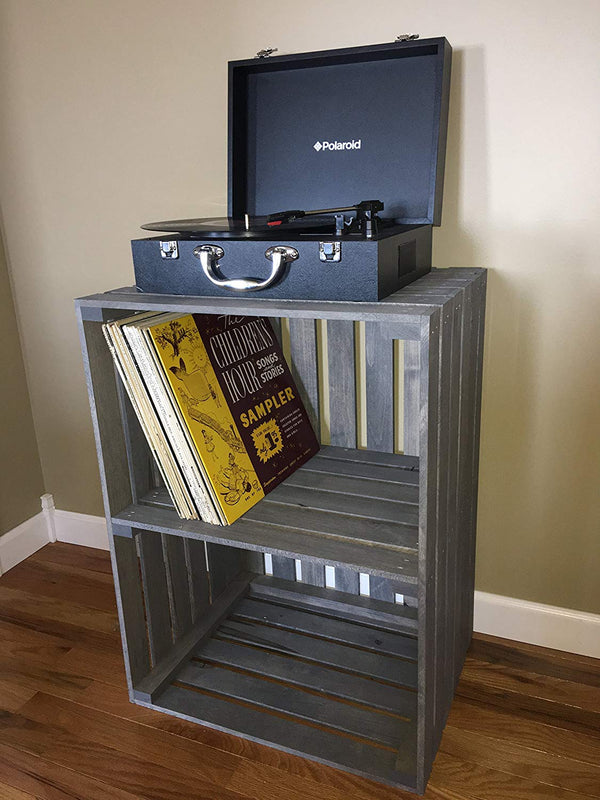 Two-tier gray wooden turntable stand with record player and vinyl storage.