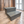Rustic gray wood 2-step pet stairs on hardwood flooring, farmhouse-style pet furniture.