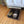 Wooden dog bed with medium brown stain, includes cushion and pet toys
