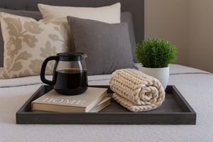Large gray serving tray on a bed styled with coffee, books, and a cozy blanket for farmhouse decor.