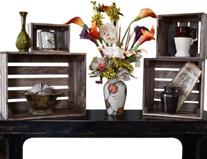 Rustic wooden nesting crates styled with farmhouse decor and flowers.