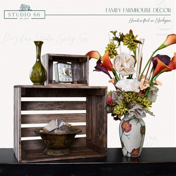 Farmhouse nesting crate set with rustic decor and green vase on table.