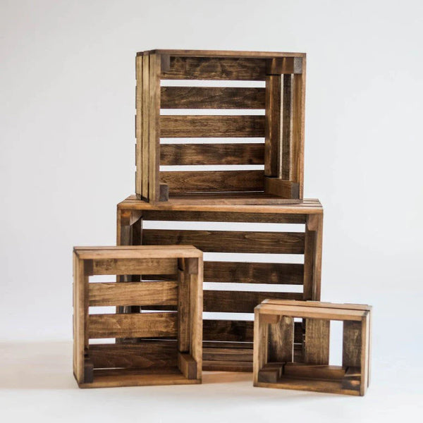 Rustic nesting crate set stacked in four sizes on white background.