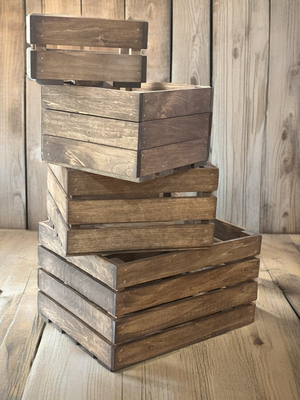 Farmhouse nesting crates stacked in rustic home setting with wood backdrop.