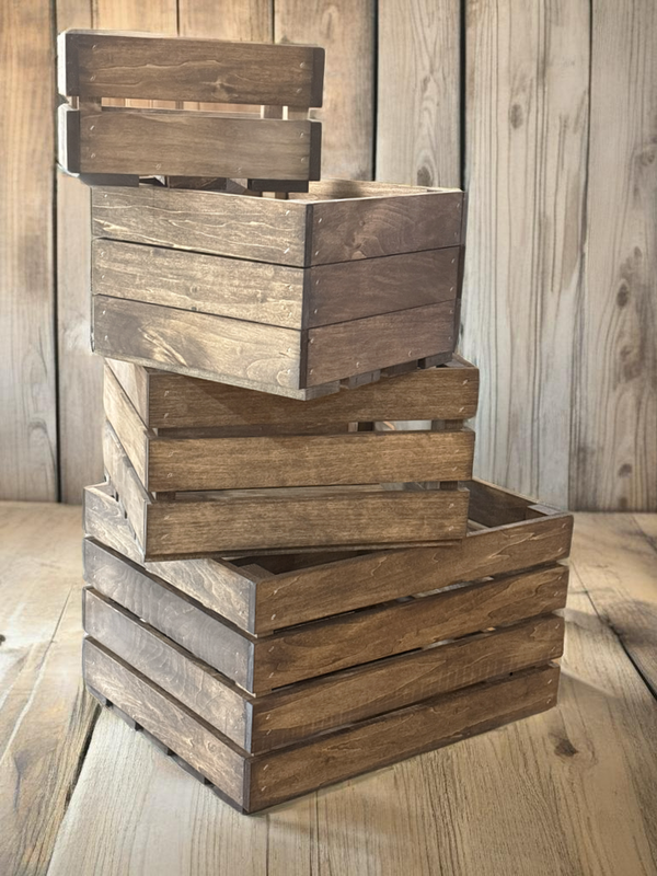 Farmhouse nesting crates stacked in rustic home setting with wood backdrop.