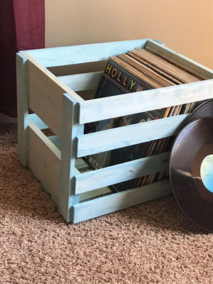 Vintage Blue wooden record crate holding vinyl LPs on carpet