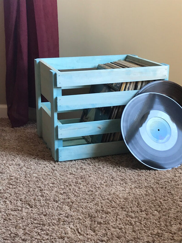 Vintage Blue record crate with vinyl albums and loose record