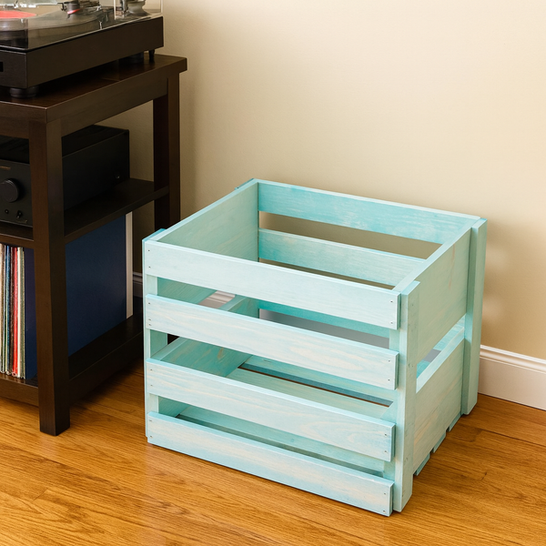 Vintage Blue LP holder crate beside a turntable stand