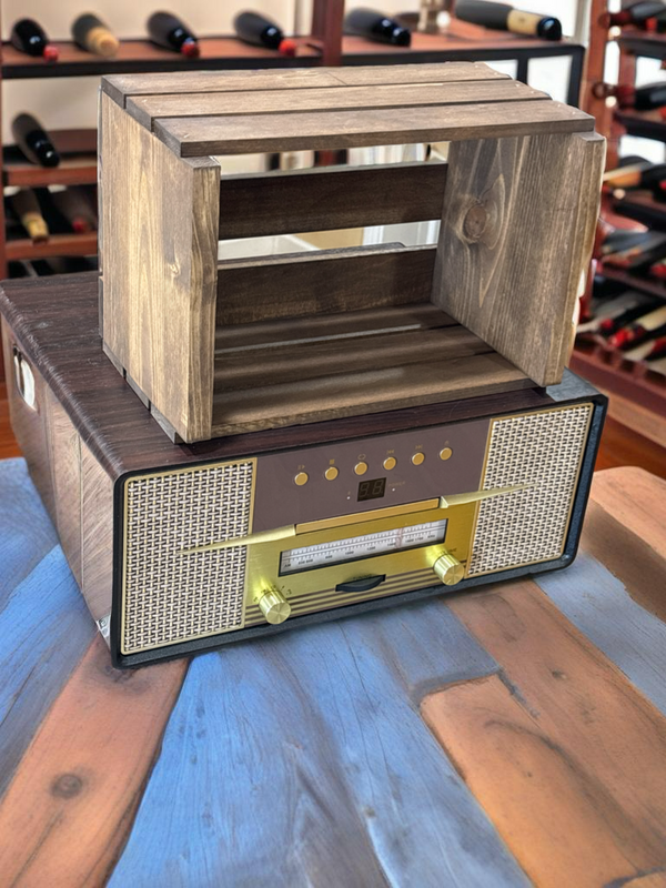 Medium 45 RPM vinyl record crate displayed on top of vintage radio