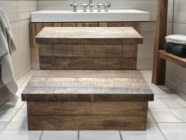Medium brown wooden 2-step stool styled in a bathroom setting near a sink and towels.