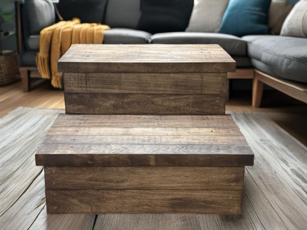 Medium brown rustic 2-step stool displayed in a modern living room with sofa and throw blanket.