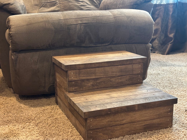 Side view of a rustic medium brown stained 2-step wooden stool on carpet.