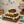 Rustic 3-tier medium wood cupcake stand with cupcakes at a birthday party.