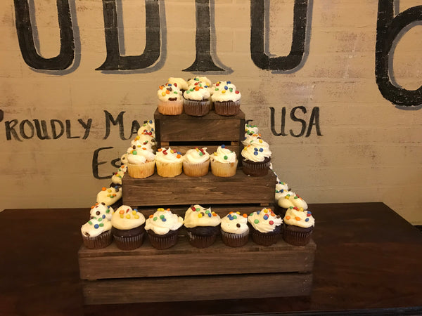 Medium-stained rustic cupcake stand with cupcakes in a studio display setting