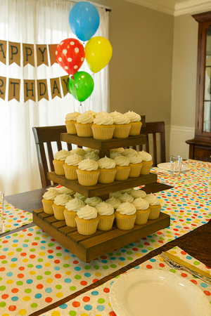Medium rustic wooden cupcake stand decorated with cupcakes for an event or party.