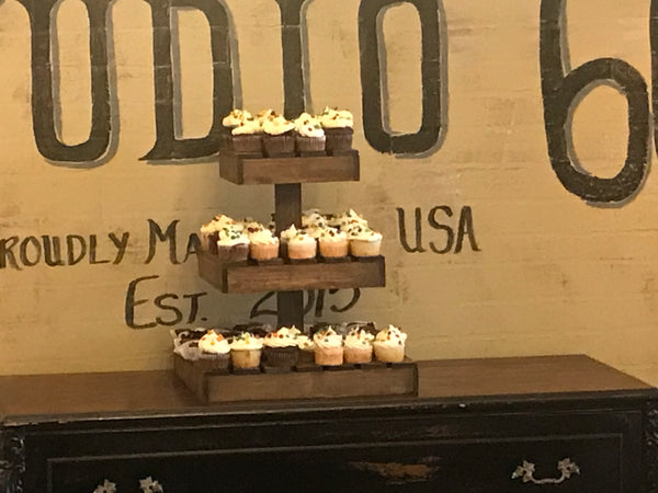 Rustic medium wooden cupcake stand holding cupcakes at a retirement party celebration.