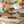 Medium tiered cupcake stand filled with colorful cupcakes, rustic handmade wood.