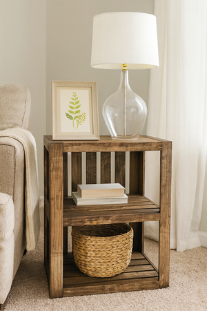 ustic medium end table styled with lamp, frame, and woven basket in cozy home setting.
