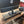 Rustic dark wood 24-inch monitor stand holding HP desktop, cable storage underneath.