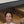 Video showcasing rustic wooden under-bed storage drawer with wheels, easy pull-out design, and black metal handle