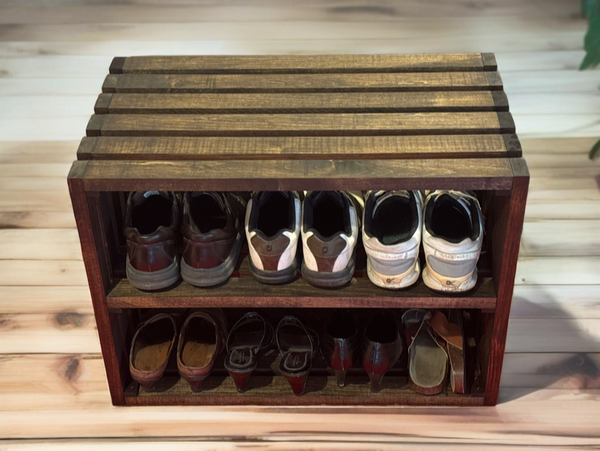 Wooden shoe rack in dark walnut holding men’s and women’s shoes on two shelves