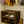 Rustic dark walnut wooden shoe rack in a closet holding women’s flats and sneakers