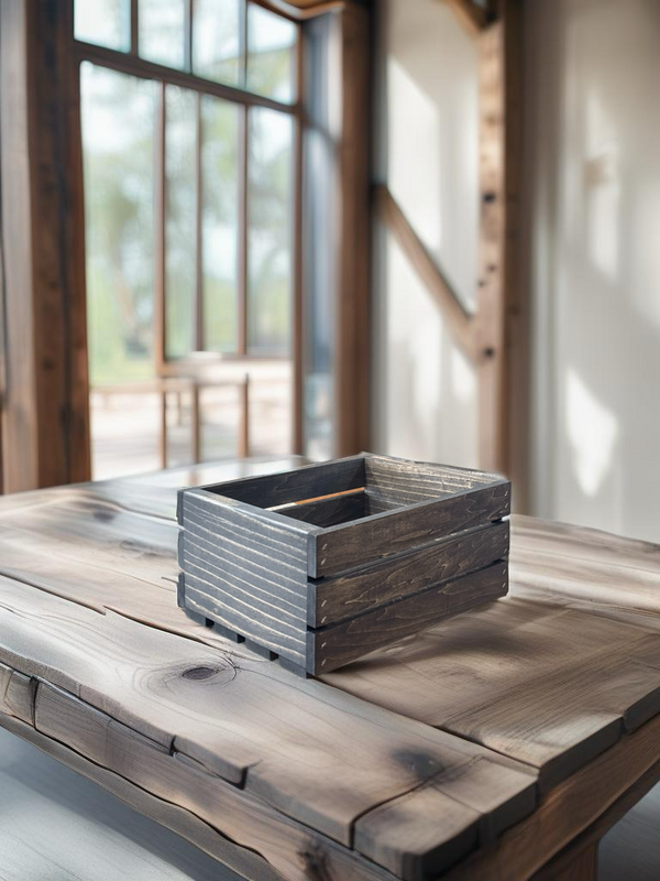 Small dark wood crate on rustic farmhouse table, decorative storage box.
