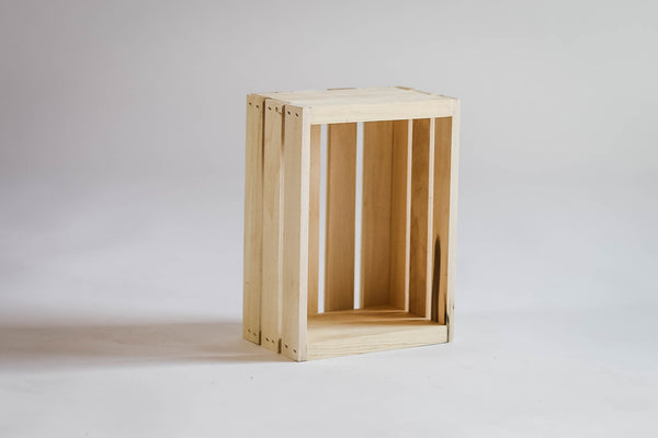 Small natural unfinished wooden crate standing upright on white background