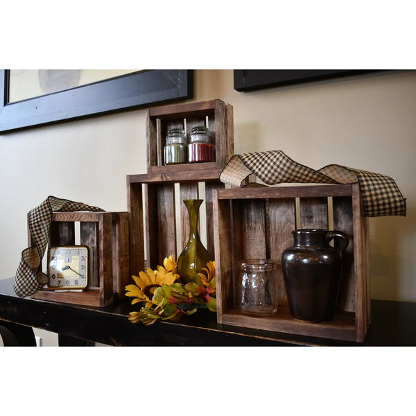 Rustic small nesting crates used as farmhouse décor display with jars, ribbon, flowers, and vintage accents.