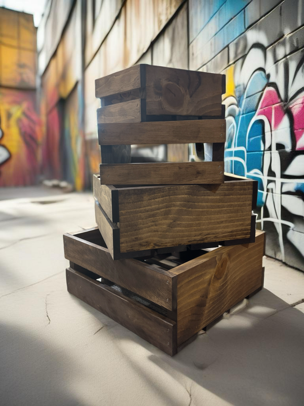 Stack of rustic small wooden nesting crates outdoors against graffiti wall backdrop