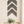 Rustic gray chevron wall art set of 3 arranged vertically on dining room wall above wood table.