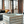 Vintage blue stained wood crate styled in modern living room with large windows.
