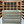 Vintage blue stained wooden crate displayed in wine cellar with wood shelves.