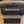 Front view of rustic vintage dark stained 2-step wooden stool on carpet, handmade pet steps.