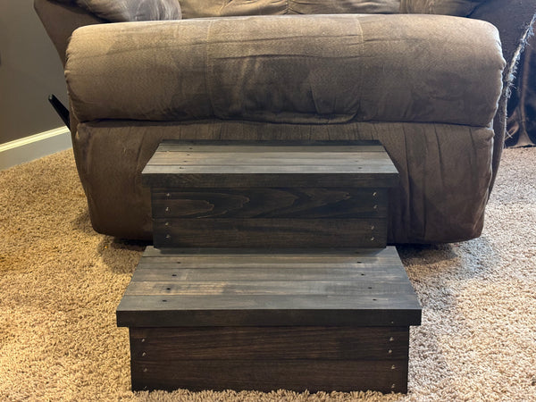 Front view of rustic vintage dark stained 2-step wooden stool on carpet, handmade pet steps.