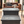 Rustic 2-step stool in vintage dark wood finish placed in a modern living room with natural light.