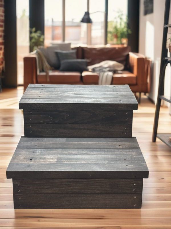 Rustic 2-step stool in vintage dark wood finish placed in a modern living room with natural light.