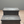Rustic farmhouse 2-step wooden stool in vintage dark stain against a neutral wall background.